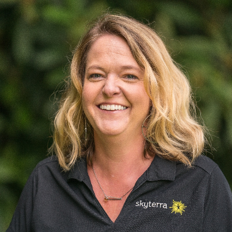 Guest services representative pictured outside on Skyterra Young Adult's campus
